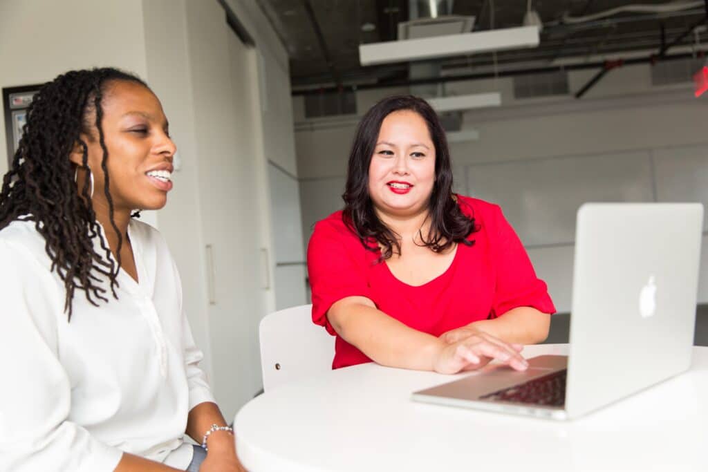 two businesswomen working on a laptop